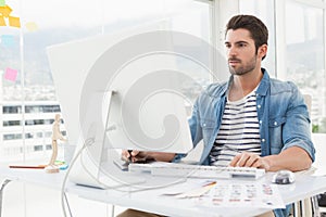 Focused designer working with digitizer and computer