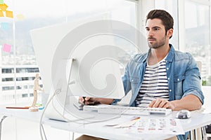Focused designer working with digitizer and computer photo