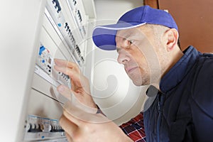 focused electrician by central fusebox
