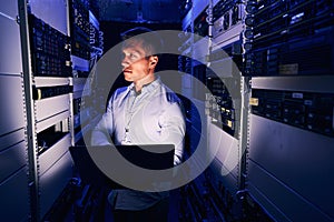 Focused expert system administrator examining computer hardware