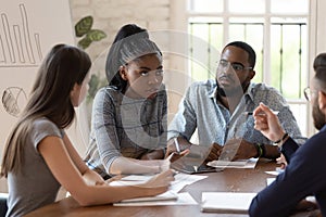 Focused female black executive teaching training workers at office briefing photo