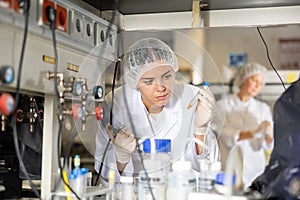 Focused female technician working in research laboratory