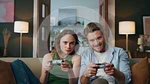 Focused friends holding controllers playing game at home pov. Couple videogame