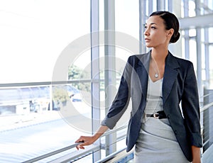 Always focused on the future. A thoughtful businesswoman gazing out of the window.