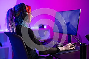 Focused Gamer Playing first-person shooter in a Vibrant, Colorful Room