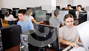 Focused girl using scanner in computer room