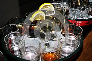 Focused glass of vermouth with a slice of lemon, thinly lined top of the glass with a layer of sweet sugar in the restaurant