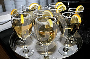 Focused glass of vermouth with a slice of lemon, thinly lined top of the glass with a layer of sweet sugar in the restaurant