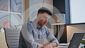 Focused guy working laptop in buro closeup. Stressed nervous man trying to calm