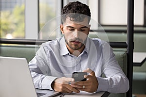 Focused handsome Arab freelance professional man using modern online technology