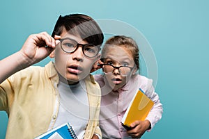 Focused interracial schoolkids in eyeglasses 