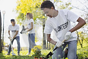 Focused male volunteer trying gardening