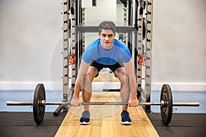 Focused man about to lift a barbell