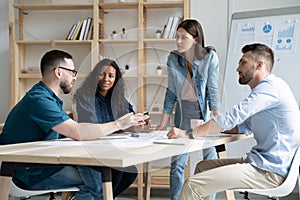 Focused mixed race business people company employees discussing project.