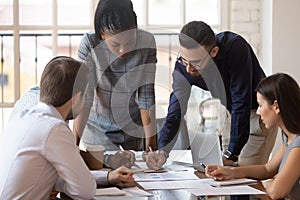 Focused multiracial corporate business team people brainstorm on paperwork photo