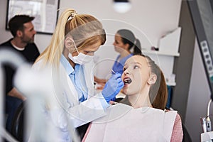 Focused orthodontist using dental mirror