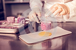 Focused photo on female hands that creating dessert