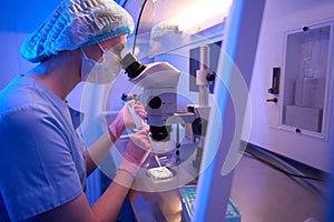 Focused researcher preparing biological samples for microscopic examination