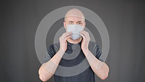 Focused responsible man wearing protective mask