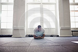 Senior man in sportswear planking on a gym floor photo