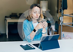 .Focused serious white young woman works in a remote office photo