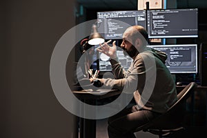 Focused software engineer thinking about source code