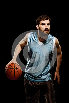 Focused sportsman dribbling a basketball