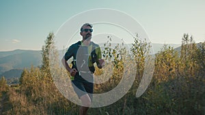 Focused sporty Caucasian guy jogger man runner jog sportswear sport male intense run marathon trail endurance challenge