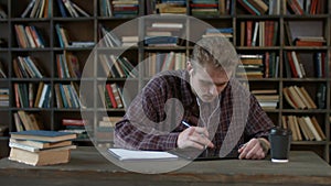 Focused student with tablet pc browsing the net