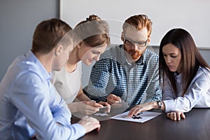 Focused team people assembling puzzle finding business solutions