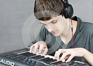 Focused Teen Plays Keyboard