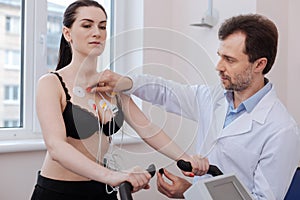 Focused trained cardiologist connecting electrodes