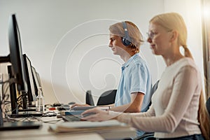 Focused university student using computer studying in computer room