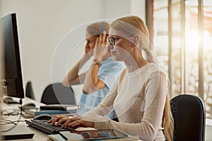 Focused university student using computer studying in computer room