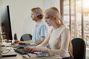 Focused university student using computer studying in computer room