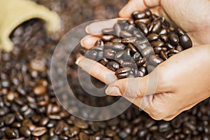 Focused view of a grasp of coffee beans