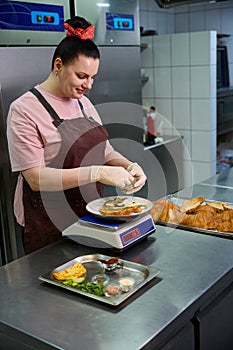 Focused woman cooking the crois-sandwich, following the recipe