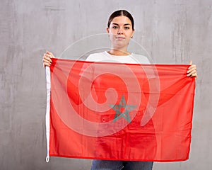 Focused woman holding flag of Morocco