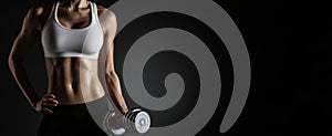 The focused woman lifting a dumbbell in an intense workout setting. AI generated image photo