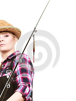 Focused woman looking at fishing rod float