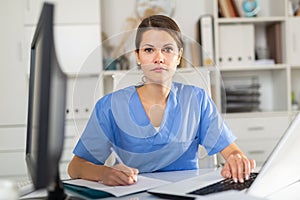 Focused woman physician listening to patient complaints at clinic