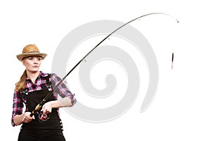 Focused woman in sun hat holding fishing rod