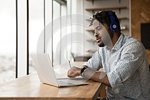 Focused young african american man studying on online courses.