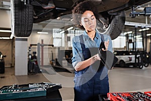 focused young african american mechanic standing