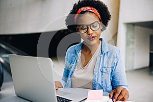 Focused young African female entrepreneur working on her busines