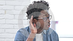 Focused Young African Man trying to Hear