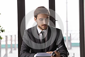 Caucasian businessman work with day planner in office