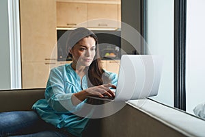 Serious long-haired lady staring at her computer photo