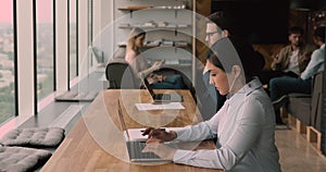 Focused young indian ethnicity businesswoman working on computer online.