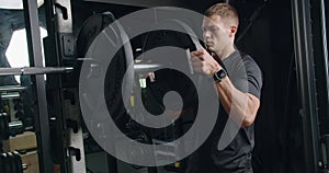 Focused Young Man Preparing To Lift Weights in a Modern Gym